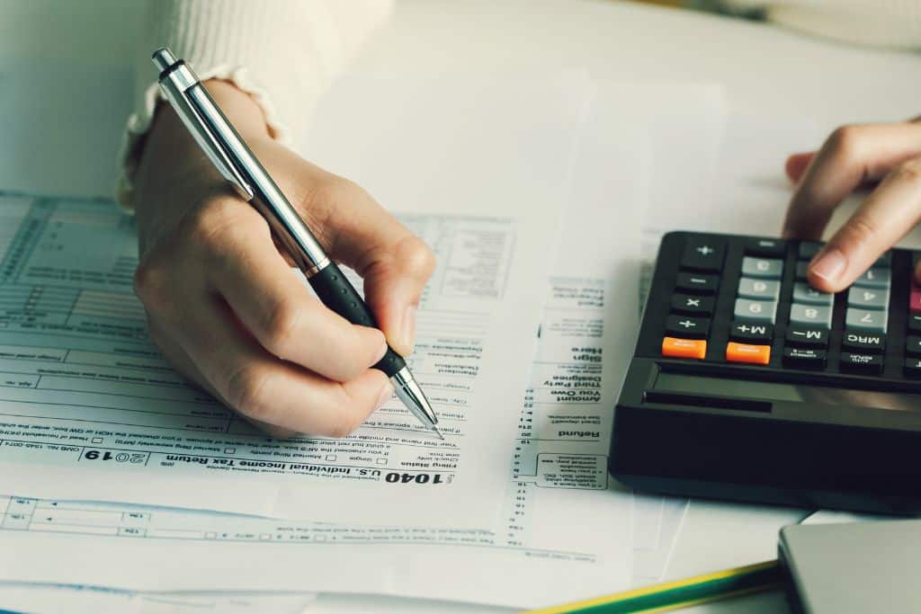 A professional accountant seated at a desk, meticulously reviewing and preparing a tax return