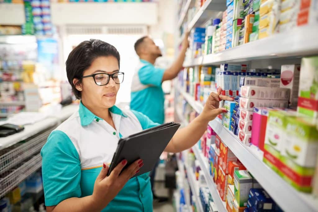 A well-organized pharmacy storage area with neatly arranged shelves, medicine bottles, and labels, showcasing efficient pharmacy inventory management practices.