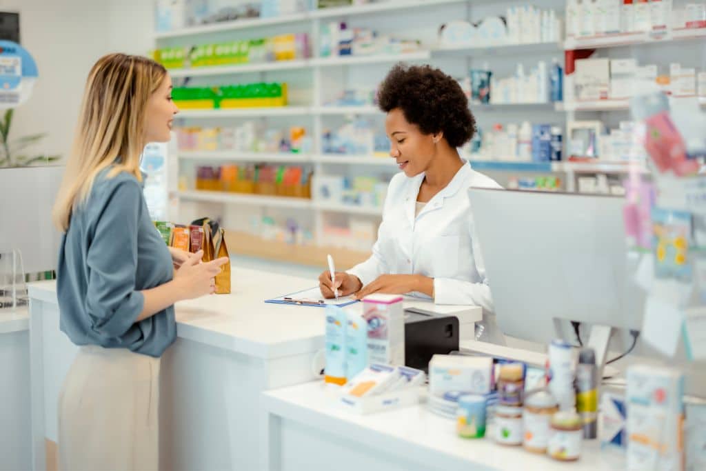 A pharmacist reviewing financial documents and tax forms
