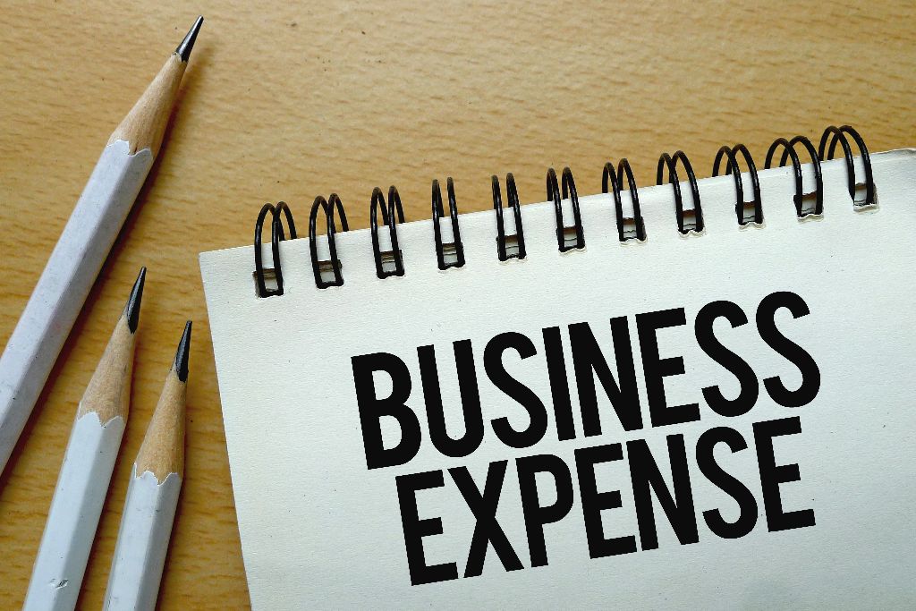 business expense text written on notebook