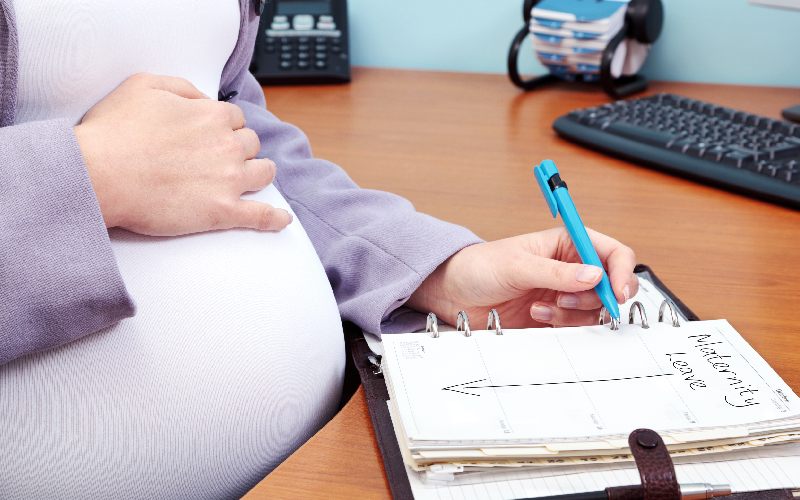 photo pregnant woman office writing words