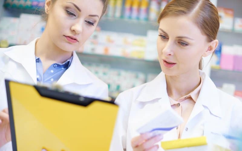 two-young-pharmacistsdoing-paperwork