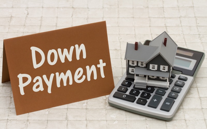 home mortgage down payment-a-gray-house brown card and calcula