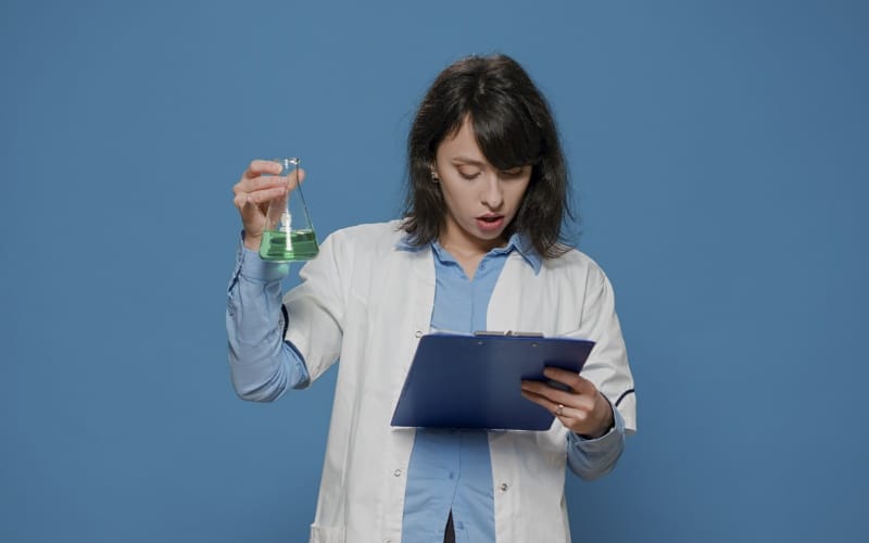 female scientist analyzing liquid beaker chemistry